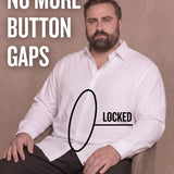 White man sitting on a chair wearing a white long-sleeve dress shirt, pointing at the button placket to show no button gap, front view