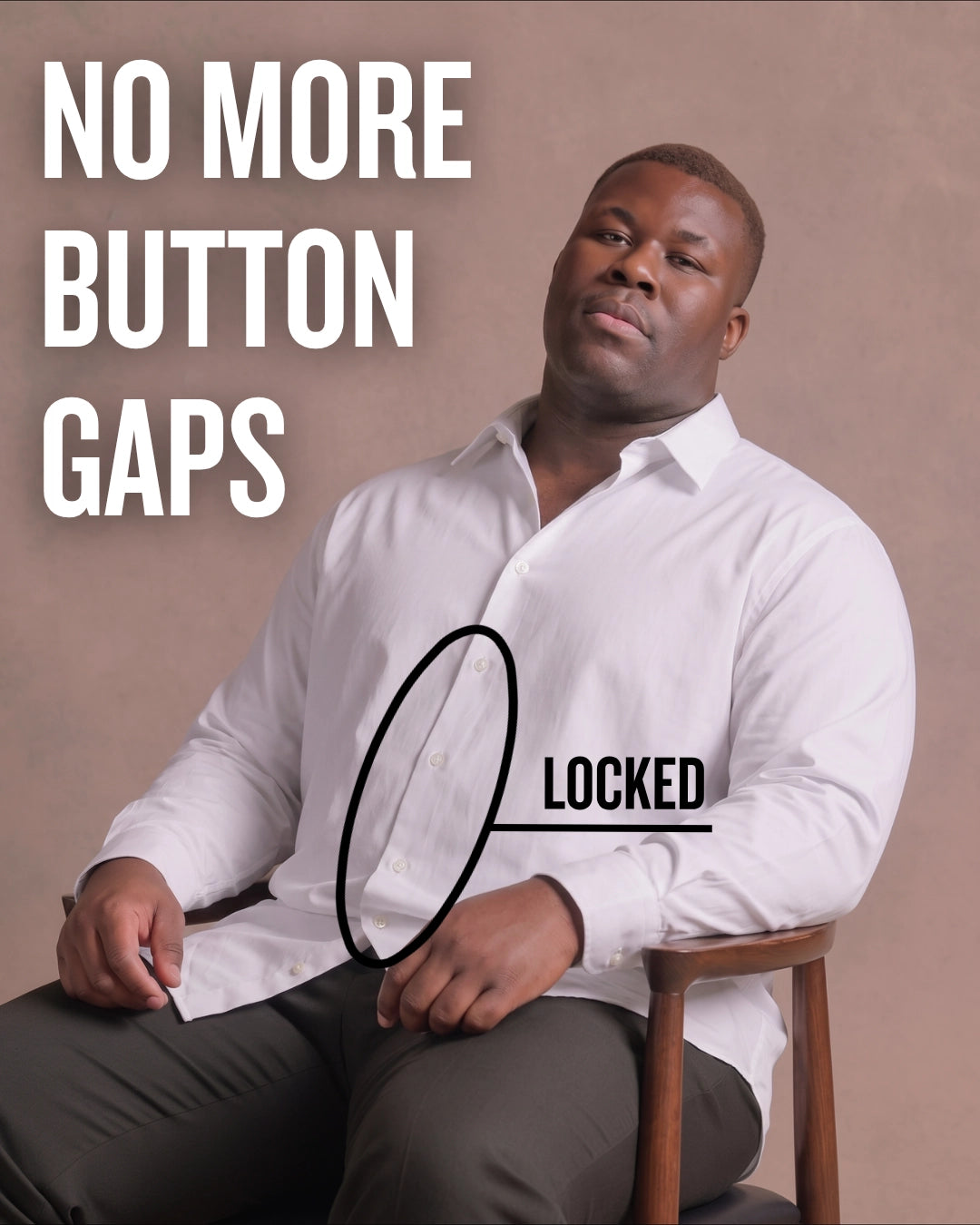 Black man sitting on a chair wearing a white long-sleeve dress shirt, pointing at the button placket to show no button gap, front view