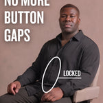Black man sitting on a chair wearing a black long-sleeve dress shirt, pointing at the button placket to show no button gap, front view
