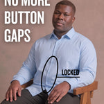 Black man sitting on a chair wearing a light blue long-sleeve dress shirt, pointing at the button placket to show no button gap, front view