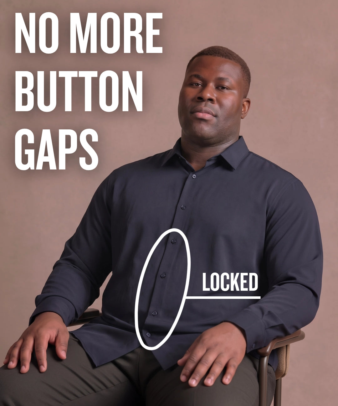 Black man sitting on a chair wearing a navy long-sleeve dress shirt, pointing at the button placket to show no button gap, front view
