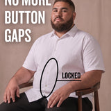White man sitting on a chair wearing a white short-sleeve dress shirt, pointing at the button placket to show no button gap, front view