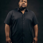 Plus-size Black man trying on NEVER GAPE No-Gap Stretch Dress Shirt in Black, Short Sleeve, front view