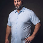 Plus-size white man trying on NEVER GAPE No-Gap Stretch Dress Shirt in Light Blue, Short Sleeve, side view