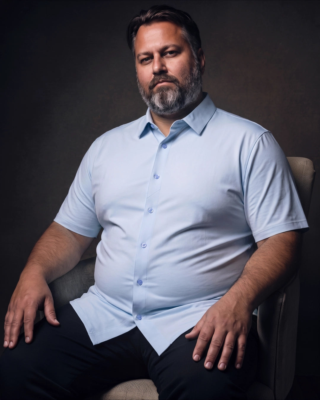 Plus-size white man sitting in a chair wearing NEVER GAPE No-Gap Stretch Dress Shirt in Light Blue, Short Sleeve