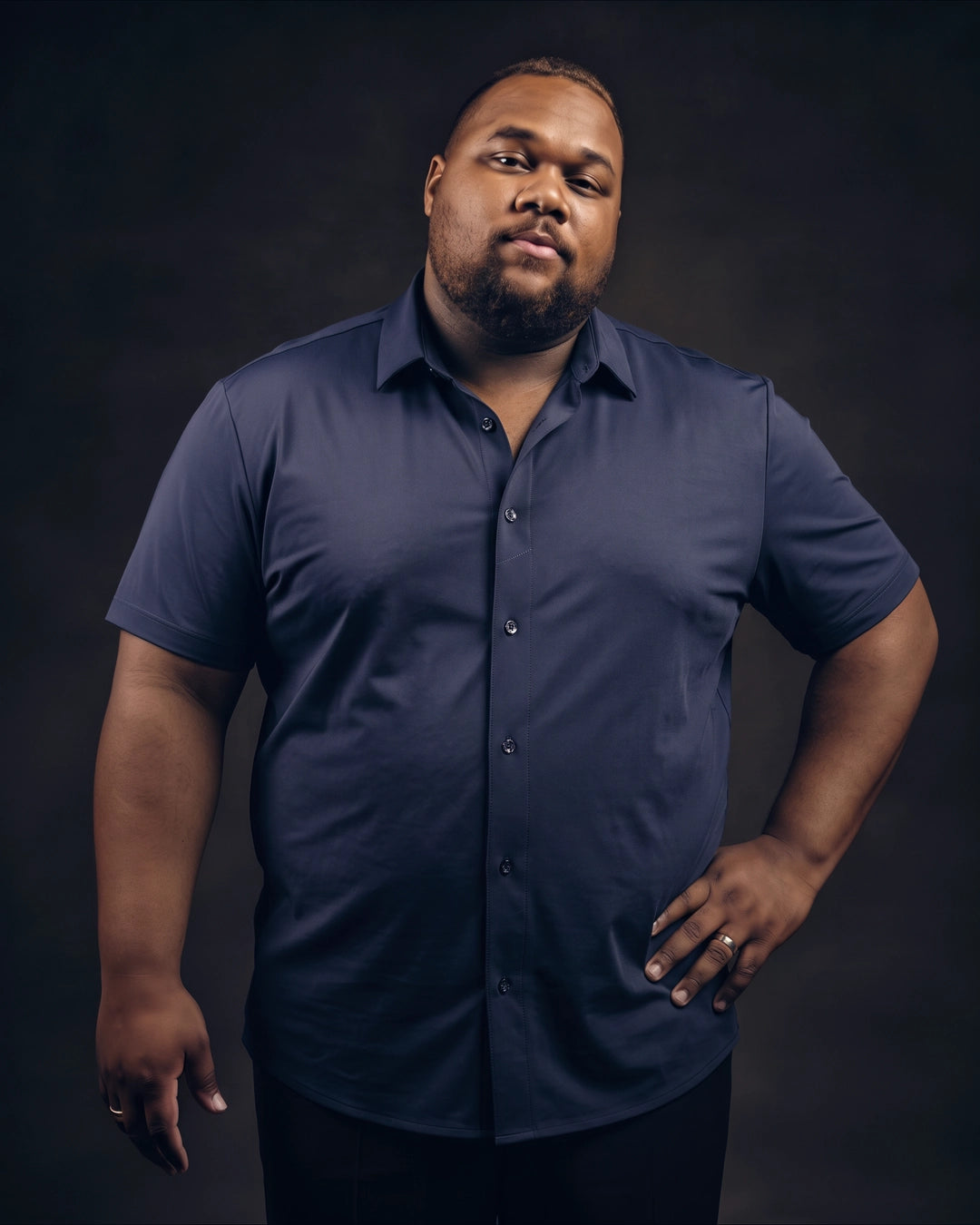 Plus-size Black man trying on NEVER GAPE No-Gap Stretch Dress Shirt in Navy, Short Sleeve, front view