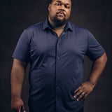 Plus-size Black man trying on NEVER GAPE No-Gap Stretch Dress Shirt in Navy, Short Sleeve, front view