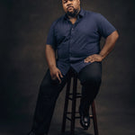 Plus-size Black man sitting in a chair wearing NEVER GAPE No-Gap Stretch Dress Shirt in Navy, Short Sleeve