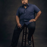Plus-size Black man sitting in a chair wearing NEVER GAPE No-Gap Stretch Dress Shirt in Navy, Short Sleeve