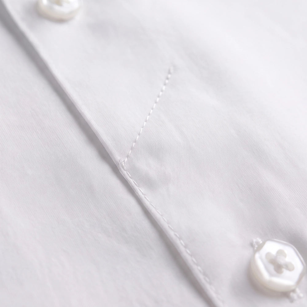 Close-up view of a men's dress shirt showing a button-lock design with buttons 4–7 securely sewn into the placket