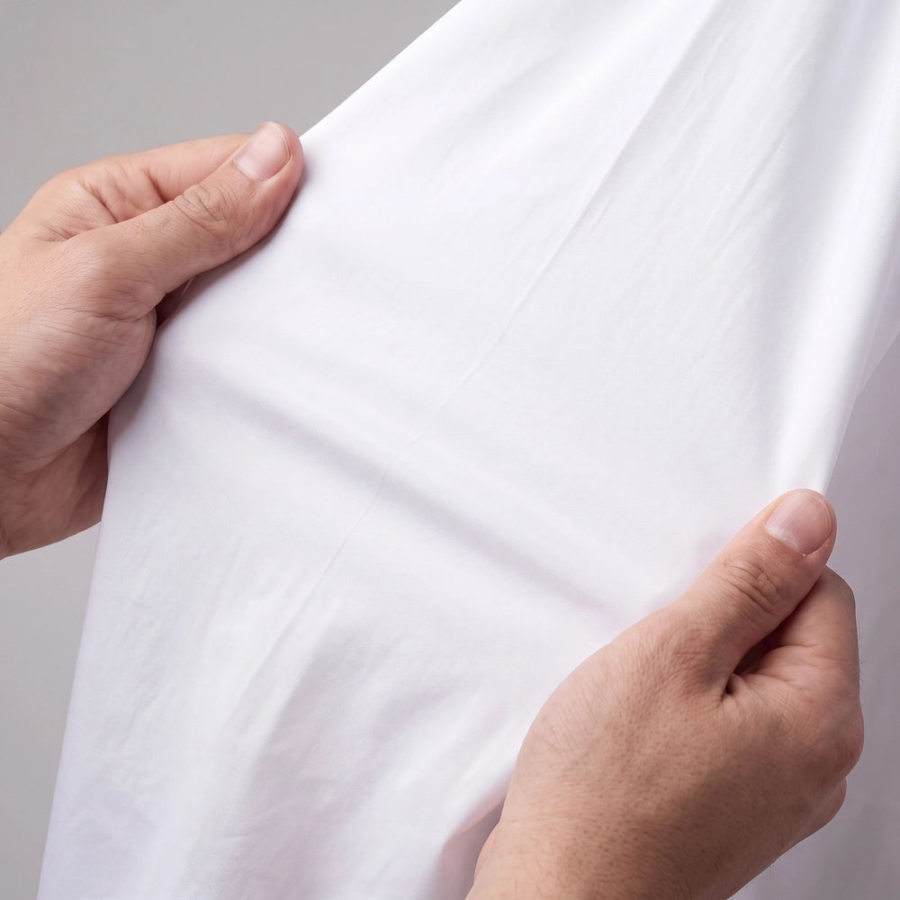 Close-up view of men's dress shirt fabric being stretched in multiple directions to demonstrate 4-way stretch flexibility
