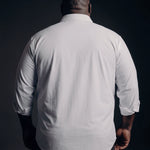 Plus-size Black man trying on NEVER GAPE No-Gap Stretch Dress Shirt in White, Long Sleeve, back view