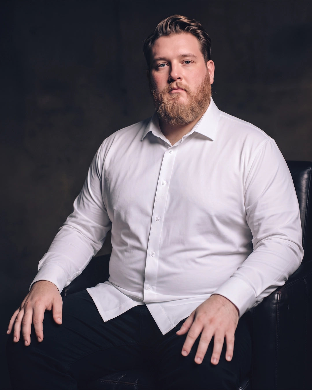 Plus-size white man sitting in a chair wearing NEVER GAPE No-Gap Stretch Dress Shirt in White, Long Sleeve