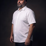 Plus-size white man trying on NEVER GAPE No-Gap Stretch Dress Shirt in White, Short Sleeve, side view