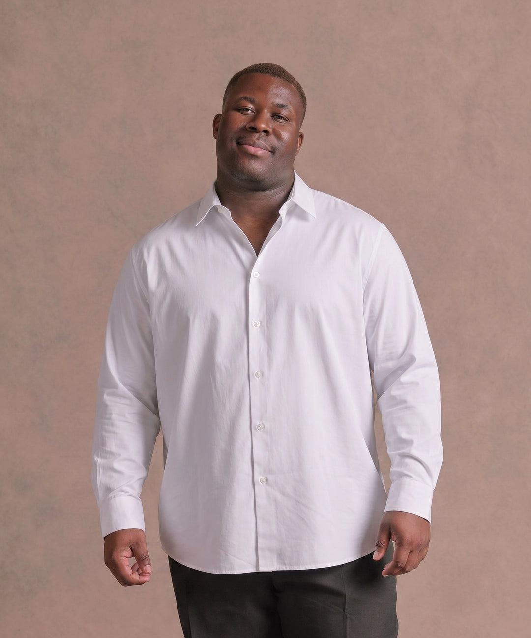 Black man wearing a white long-sleeve dress shirt, front view