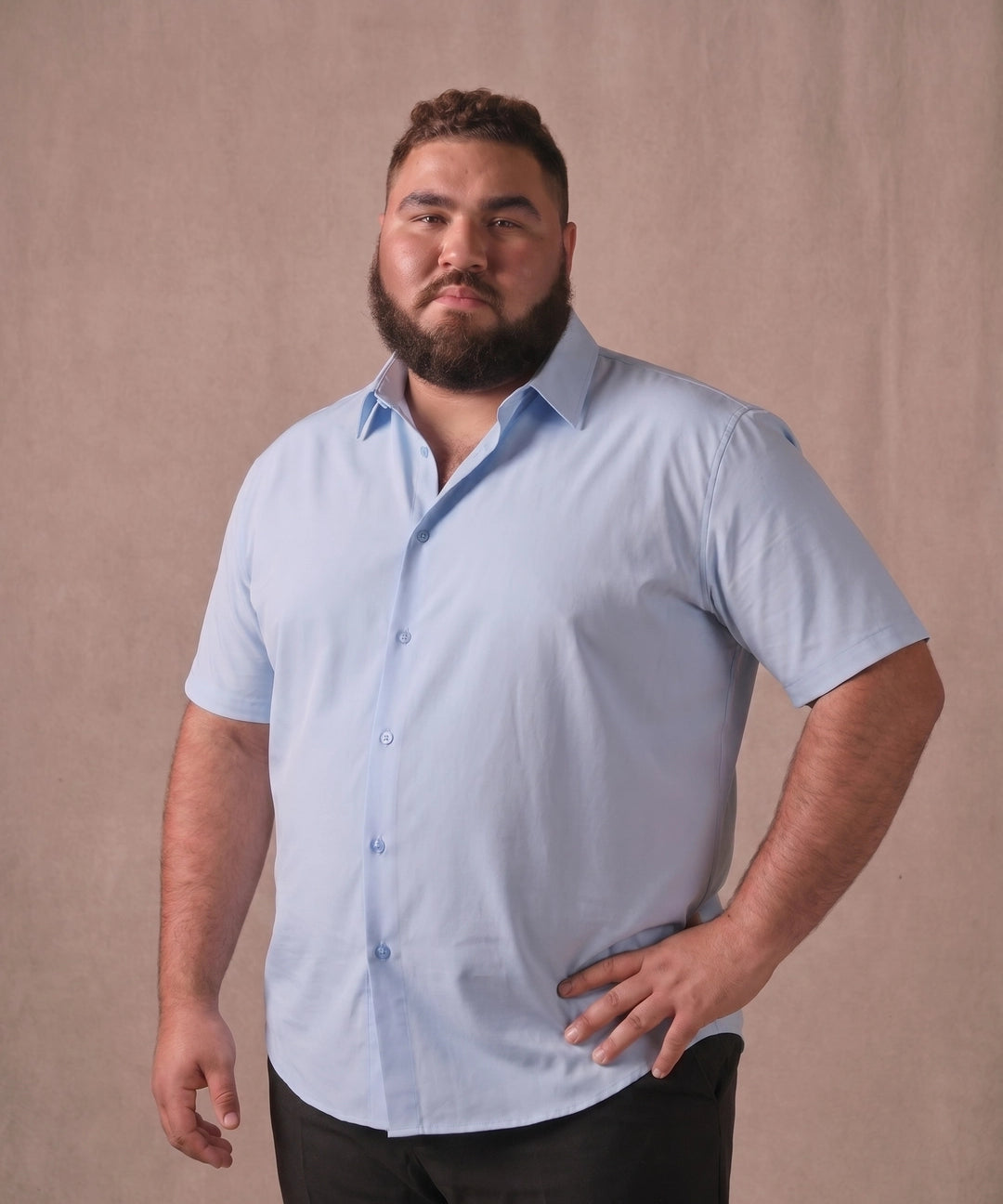 White man wearing a light blue short-sleeve dress shirt, front view
